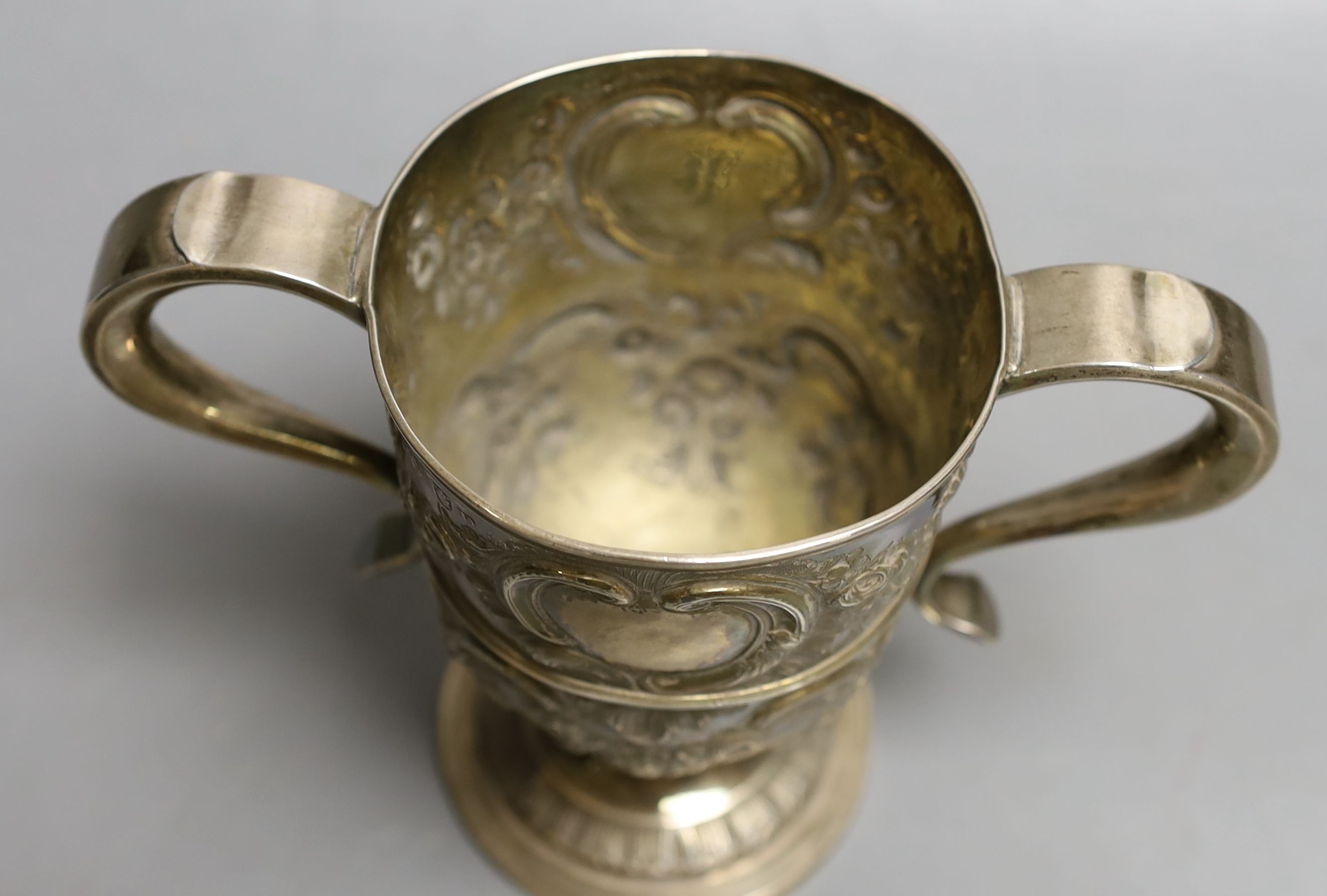 A George III provincial silver two handled pedestal cup, with later embossed decoration, Langlands & Robertson Newcastle, 1794, height 14.7cm, 10.5oz.